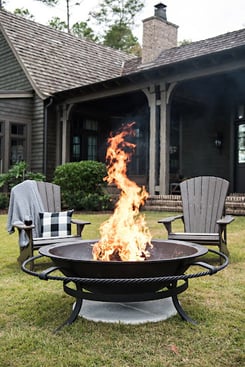 lit fire kettle and Adirondack chairs 